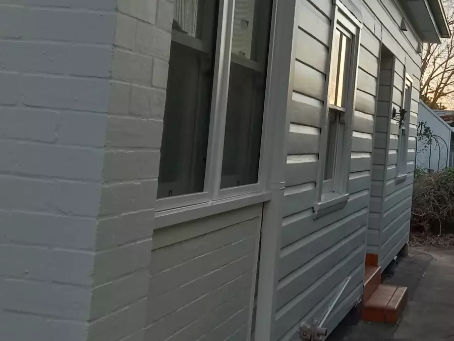 Side of timber house after exterior preparation and painting