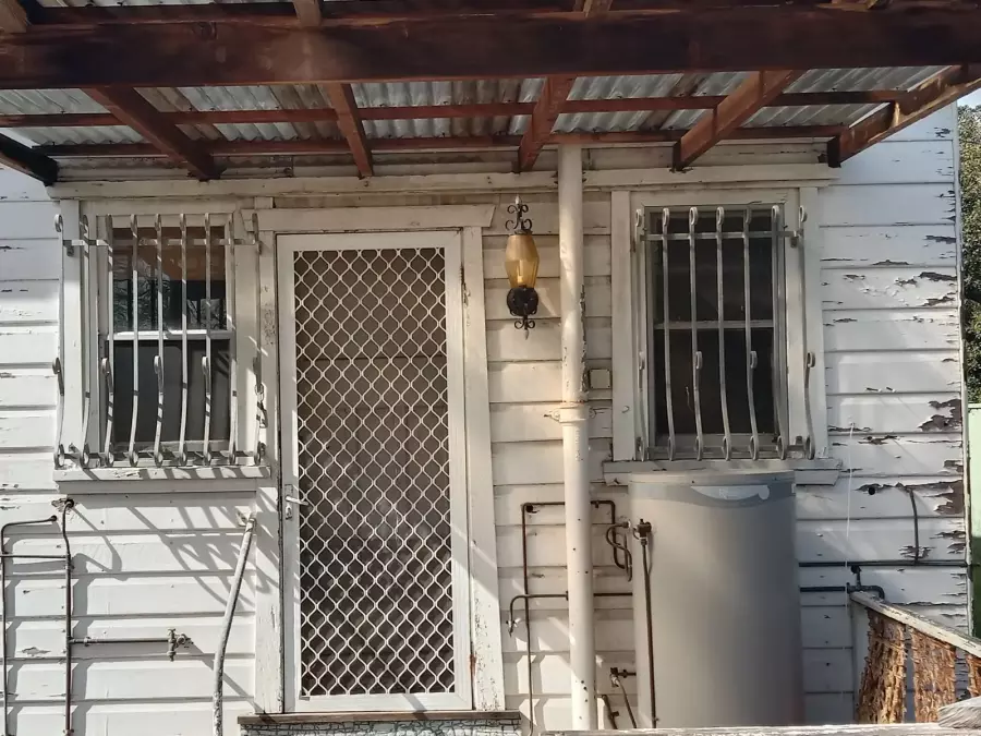 Rear entrance with peeling exterior paint before restoration